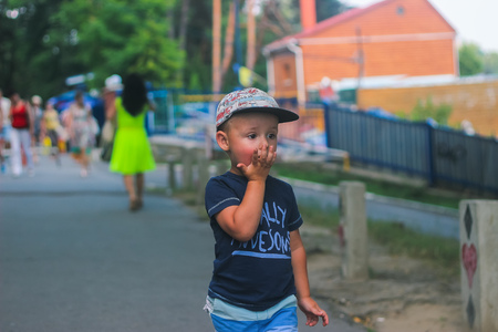 Zhytomyr, Ukraine - July 12, 2016: little boy eating something at streetのeditorial素材