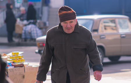 Zhytomyr, Ukraine - November 05, 2015: lonely senior walking at park, old man got lostのeditorial素材