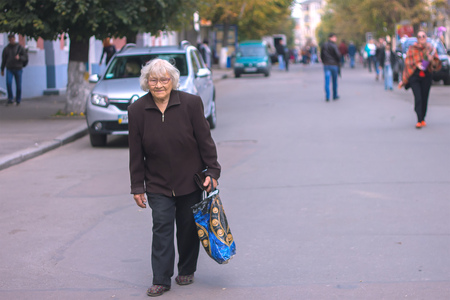 Zhytomyr, Ukraine - October 03, 2015: An older woman who comes from the shopのeditorial素材