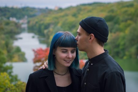 man kissing his girlfriend on the foreheadの写真素材