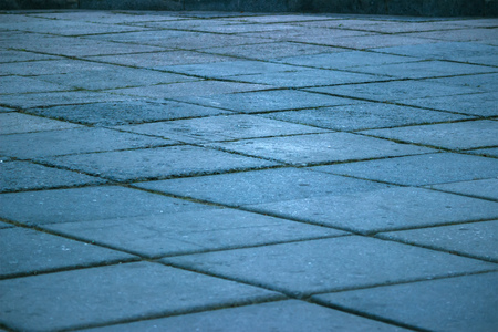 Stone pavement texture. Granite cobblestoned background at evening