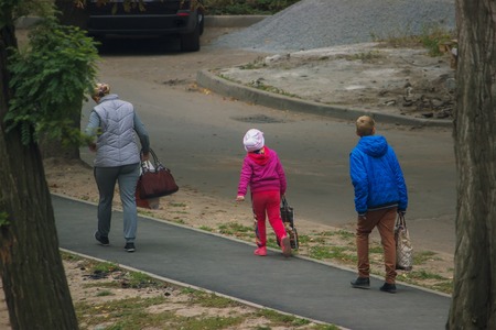 Silhouettes of people at pedestrian crossing in the streetの写真素材