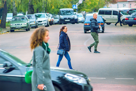 Zhytomyr, Ukraine - MAY 6, 2017: Four young people is crossing the road in wrong place