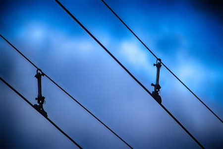Trolleybus route. Electrical wires against the evening blue sky.の写真素材