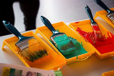 Paints and brushes with red orange and green