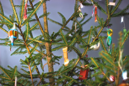 Christmas tree with baubles on the dark background.