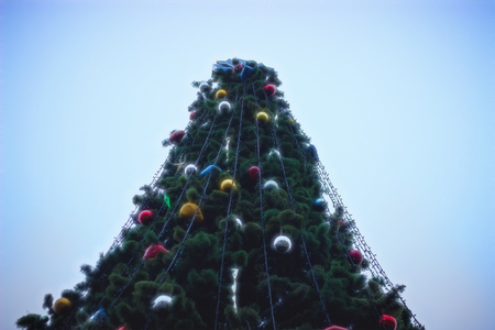 A beautifully decorated christmas tree in a town square