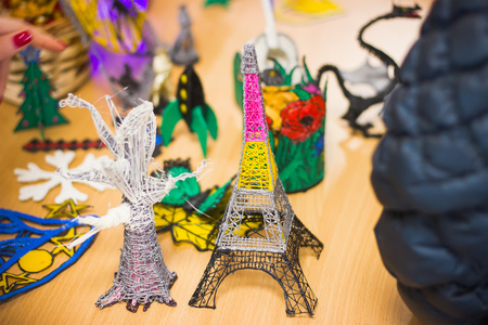 Plastic toys on the table, the Eiffel Tower from the designerの写真素材