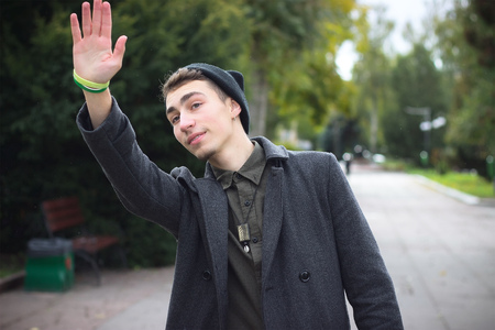 young couple holding hands while walking down the streetの写真素材