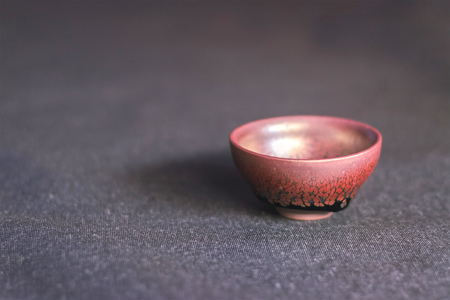 Brown and black cup for tea at gray backgroundの写真素材