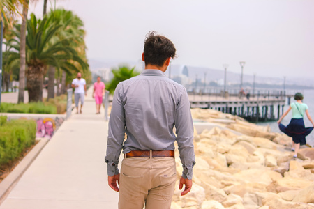 Man walking at beach in office clothesの写真素材