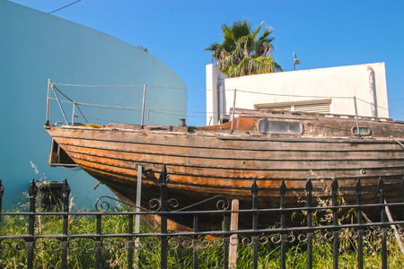 The fishing wooden boat occupies the pedestrian walkway