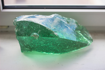 green crystal mineral at the table near windowの写真素材