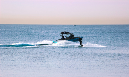 Wakeboading at front of tanker at the midday
