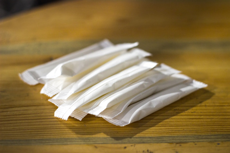 sugar sticks on the table at lightの写真素材