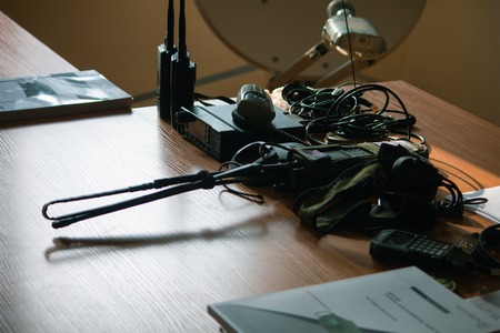 Portable walkie talkie with cords on the desk table
