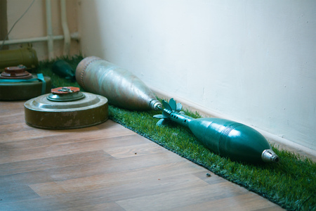 Old abandoned green anti tank mines on the floorの写真素材