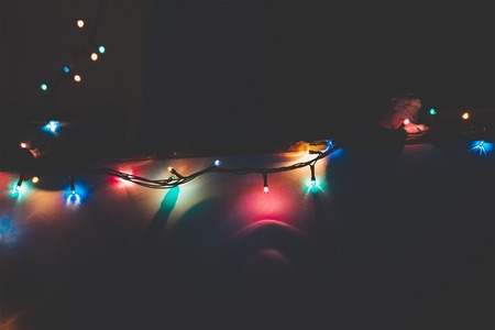 christmas garland blurred lights background with golden and violet colorsの写真素材