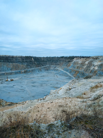 fragment of a huge mining career with working excavators, dump trucks and other quarry equipment