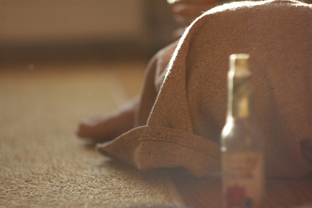 Beautiful girl in a brown linen medieval dress sitting on the floorの写真素材
