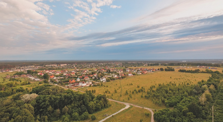 Aerial Village Surrounded with Meadows in Beautiful Spring Colours at sunsetの写真素材