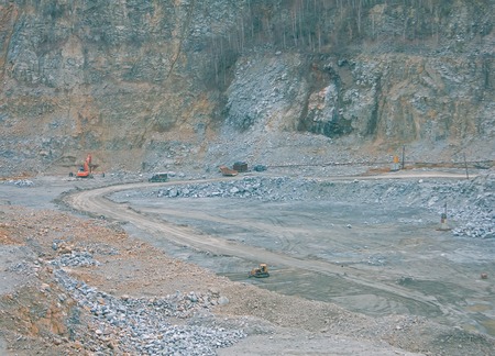 a huge mining career with working excavators, dump trucks and other quarry equipment