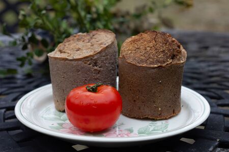 Wheat bread. Buckwheat bread with tomatoes on white plate background