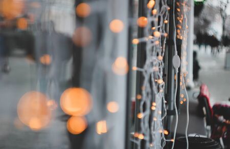 christmas garland blurred lights background with orange and green colors