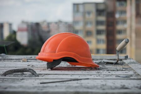 Construction plant. Working stuff on the background. An orange helmet on the foregroundの写真素材