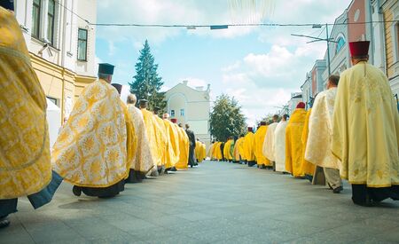 Religious procession, Priests in golden robes walk along the central street at Zhytomyr, Ukraine