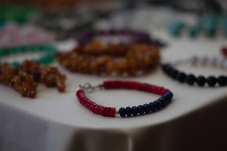 Jewelry in the background of silk. A lot of jewelry in the box. Design and bijouterie. Jewelry is...