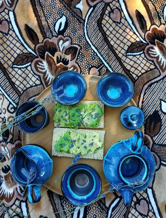 Healthy herbal lavender tea in oriental clay cupの写真素材