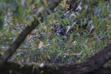 Zhytomyr, Ukraine - September 30, 2019: Realistic hunting or fisherman pattern green reeds and weeds camouflage seamless backgrounds for clothes. Fisherman hiding behind bushesのeditorial素材