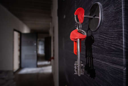 apartment key in the door from unfinished house.