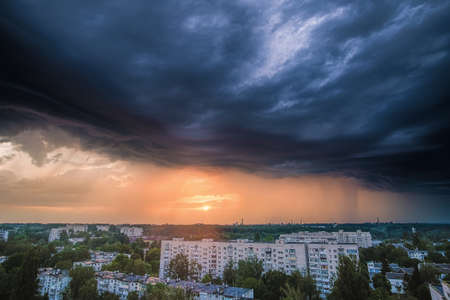 Stormy clouds above the Zhytomyr city, Ukraine. Intense sky from a rainstorm passing through. Vertical viewの写真素材