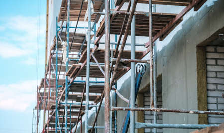 Wooden scaffolding at a construction site. Danger at building works.の写真素材