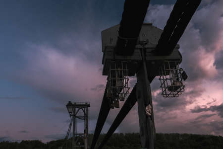 A closeup of a lock attached to the bridge at sunset with purple clouds and sky.の写真素材