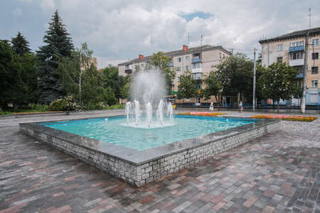 Beautiful city view in rainy weather. Typical city fountain.の写真素材
