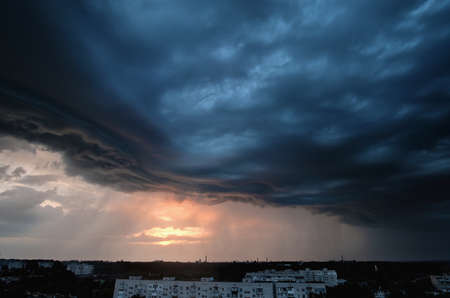 Stormy clouds above the Zhytomyr city, Ukraine. Intense sky from a rainstorm passing through. Vertical viewの写真素材