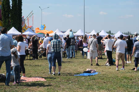 Group of aircraft fans gathered at airport festival and cheering up.のeditorial素材