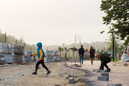 Zhytomyr, Ukraine - October 11, 2020: A child play near some construction barriers running into...