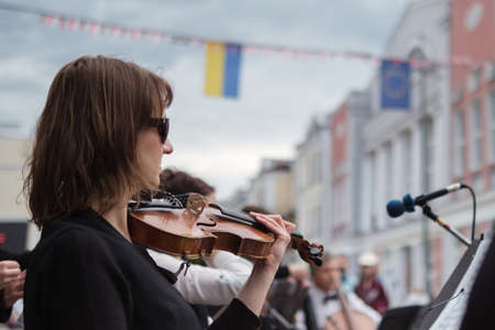 Zhytomyr, Ukraine - May 15, 2021: woman street musician playing violin classical music.