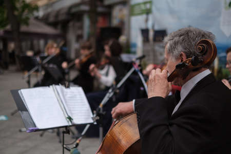 Zhytomyr, Ukraine - May 15, 2021: man street musician playing cello classical music.のeditorial素材
