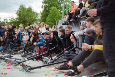 Zhytomyr, Ukraine - May 15, 2021: Skateboarders performing at a celebration. A crowd of spectators sitting, stunts on a skateboardのeditorial素材