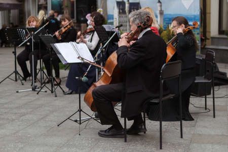 Zhytomyr, Ukraine - May 15, 2021: people street musician playing cello classical music.