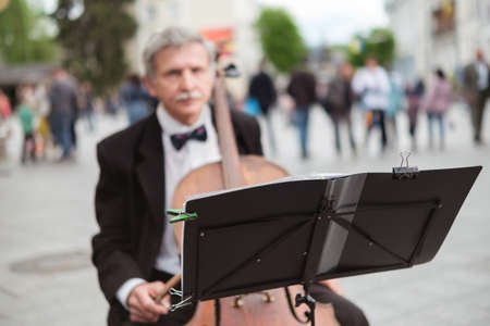 Zhytomyr, Ukraine - May 15, 2021: man street musician playing cello classical music.のeditorial素材