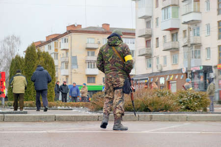 Zhytomyr, Ukraine - March 1, 2022: War of Russia against Ukraine. Member of Zhytomyr territorial defense in the city with automatic rifleのeditorial素材