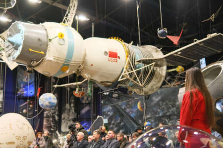 Zhytomyr, Ukraine - May 25, 2021: Girl in red space suit watching on soviet ussr satellite at museum...