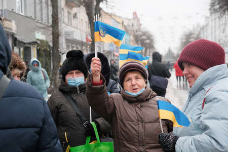Zhytomyr, Ukraine - January 21, 2022: Senior women waving the ukrainian flag at event to stop russian aggression at Ukraine, war conflict, pray for Ukraineのeditorial素材