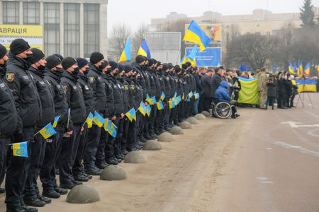 Zhytomyr, Ukraine - February 16, 2022: Ukrainian police people hold the flags of Ukraine. Patriots of their country. National Unity Day. Every year on February 16, Ukraine marks National Unity Day.のeditorial素材
